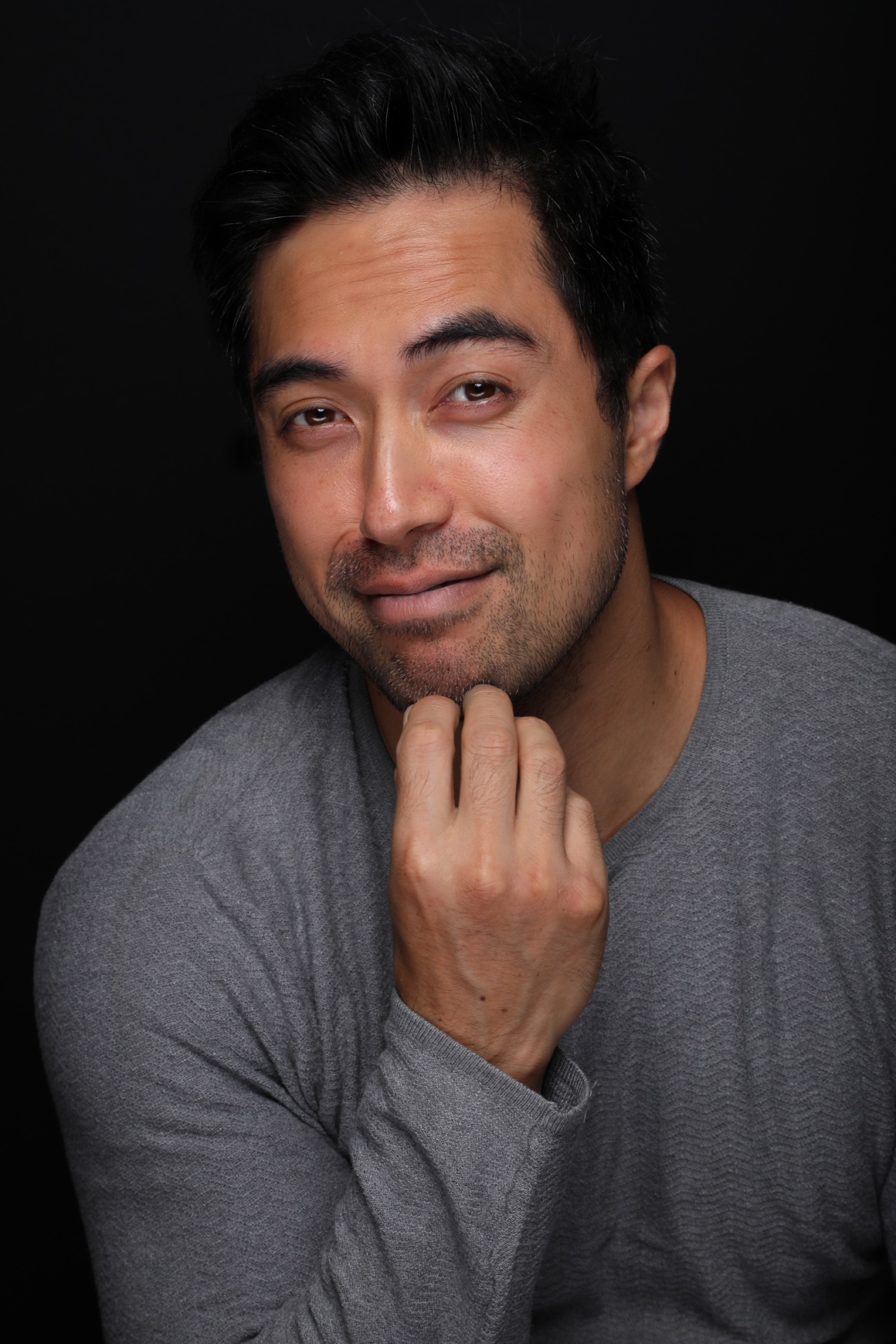 Home damien sato headshot 2025 grey mischievious web